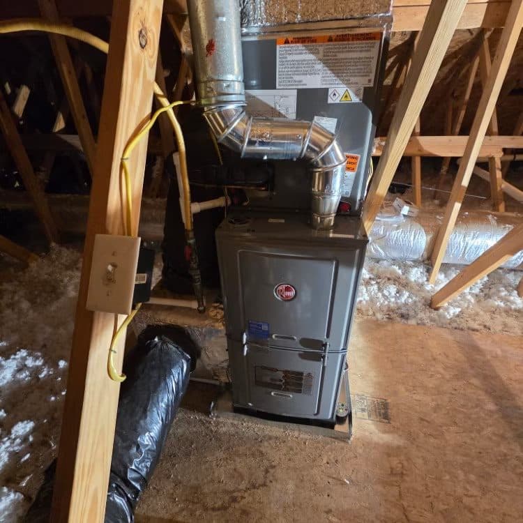 Furnace and duct system installed in an attic during new construction framing