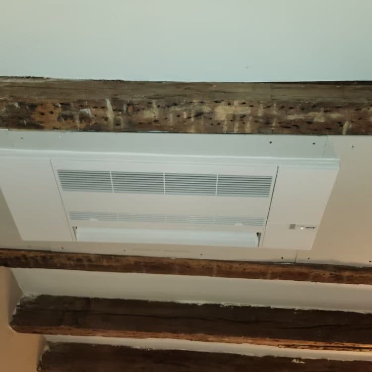 Recessed ceiling cassette mini-split installed flush between exposed beams