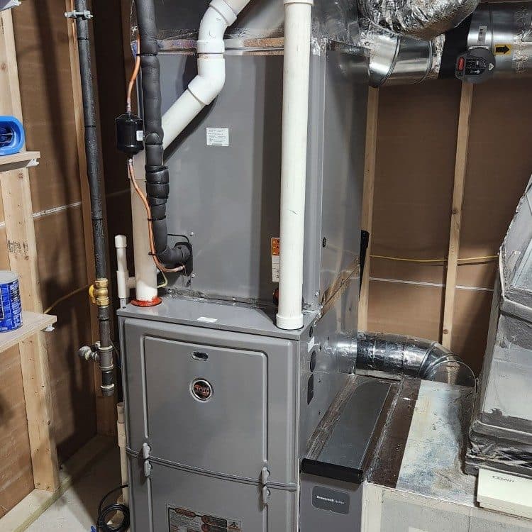 Furnace replacement completed in a narrow utility space with new duct transitions