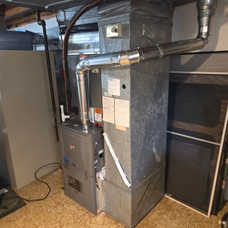 Gas furnace installed with new double-wall metal flue in a basement