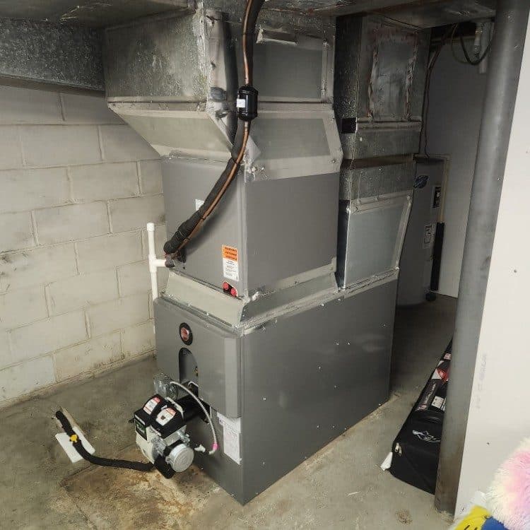 Oil-fired furnace with Beckett burner and new supply plenum in an unfinished basement