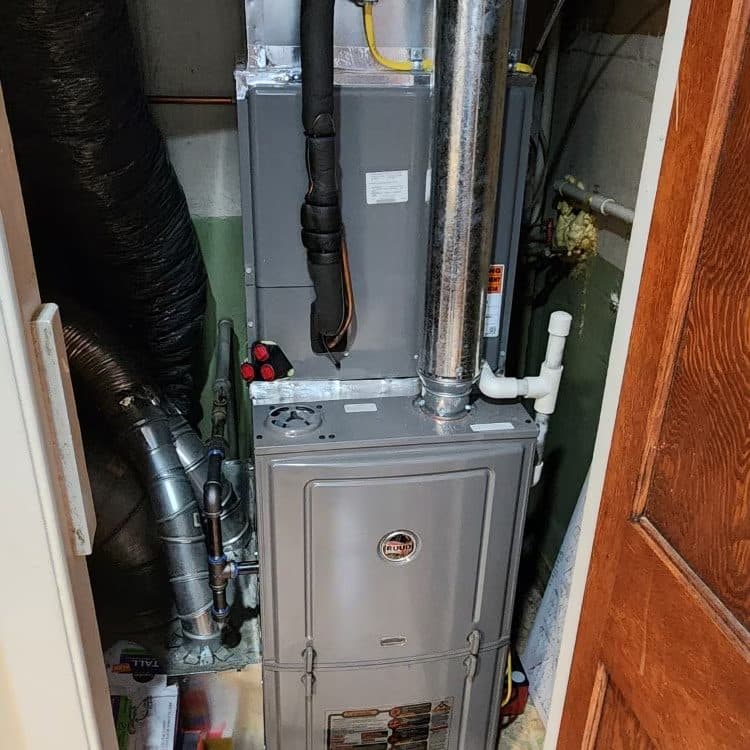 New oil-fired furnace with fabricated sheet metal plenum installed in a basement by KelAire HVAC